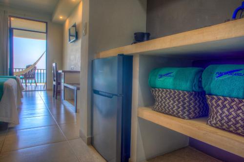 a room with a shelf with pillows on it at Punta Zicatela Hotel - Adults Only in Puerto Escondido