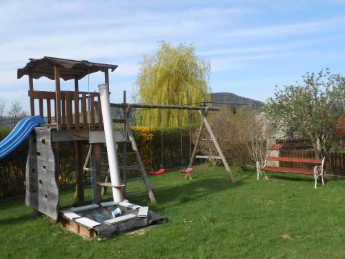 a playground with a slide and a swing at Privatzimmer Haus Gschweitl in Semriach
