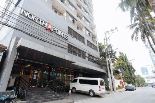 a white van parked in front of a building at Northpointe Residences in Manila