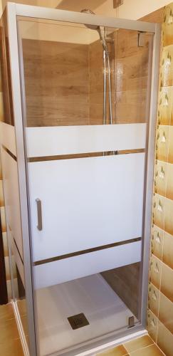 a cupboard in a kitchen with a glass door at Stella alpina in Schilpario