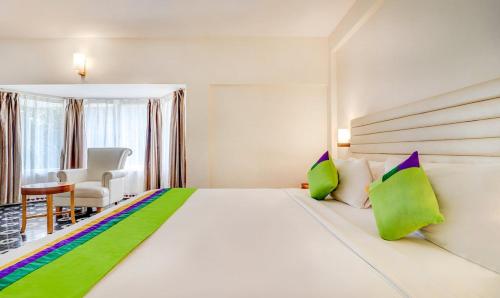 Säng eller sängar i ett rum på RR INN Group Of Hotels