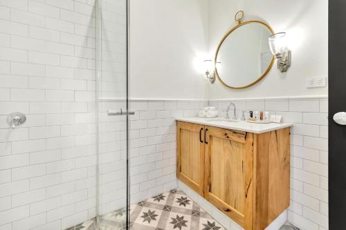 a bathroom with a sink and a shower at The National Hotel in Fremantle