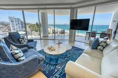 a living room with a view of the ocean at Oceans Mooloolaba in Mooloolaba