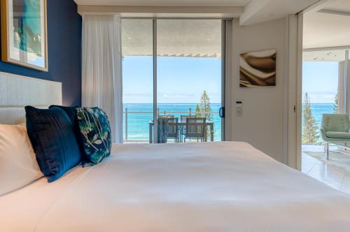 a bedroom with a bed and a view of the ocean at Oceans Mooloolaba in Mooloolaba