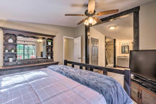 a bedroom with a bed and a ceiling fan at Relaxing Lincoln Forest Retreat with Wraparound Deck in Cloudcroft