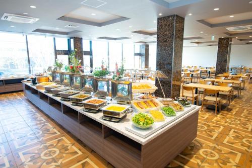 a buffet line with food on display in a restaurant at Fujikawaguchiko Resort Hotel in Fujikawaguchiko