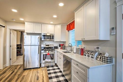a kitchen with white cabinets and a stainless steel refrigerator at Peaceful Fall Escape Oregon Home with Ocean View in Yachats