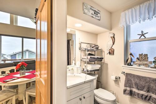 a bathroom with a sink and a toilet and a window at Epic Yachats Escape with Beach Access and Views! in Yachats