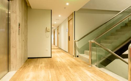 a hallway with stairs and a stair case at Yellow Bee Tanah Abang in Jakarta