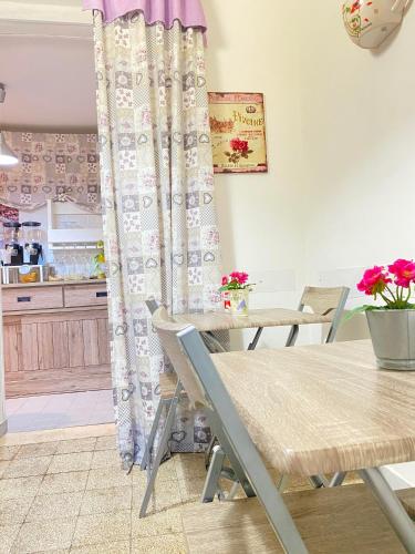 a dining room with a table and a curtain at B&B La Villetta Palese in Bari