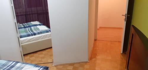 a door leading to a bedroom with a bed at Apartman centar lux in Tuzla