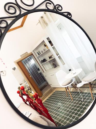 a mirror reflecting a room with two chairs and a kitchen at B&B La Villetta Palese in Bari