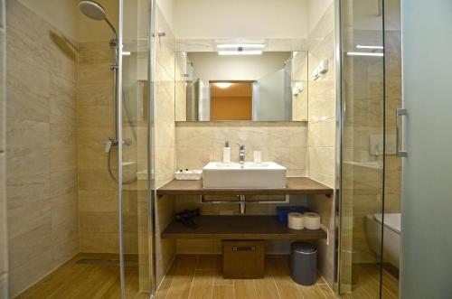 a bathroom with a sink and a shower at App & Rooms Juraga in Bale