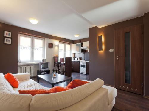 a living room with a white couch and a table at Irish Apartment in Krakow