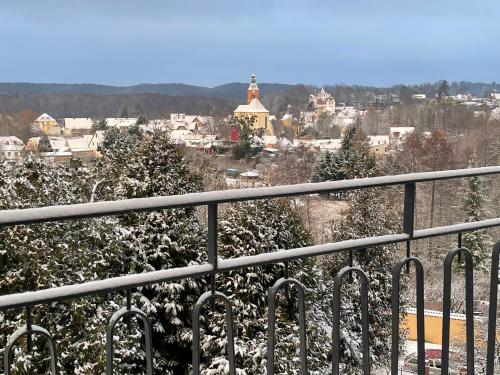 a snowy view of a city from a balcony at Hotel & Restaurant Bergschlösschen in Buckow