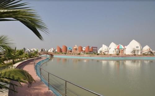 a large body of water with houses and buildings at 300M FROM BEACH GLORIAS HOTEL BEACH VIEW in Mandarmoni
