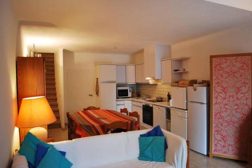 un salon avec un canapé blanc et une cuisine dans l'établissement La Cataline, magnifique duplex vue sur mer, 3 chambres, 2 sdb., à Banyuls-sur-Mer