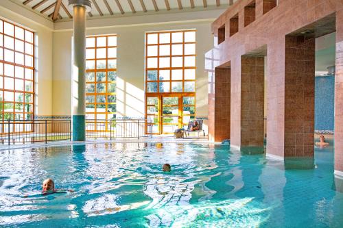 a group of people swimming in a swimming pool at ROBINSON Fleesensee in Göhren-Lebbin