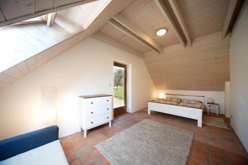 an attic room with a bed and a window at U Mišpule in Čížov