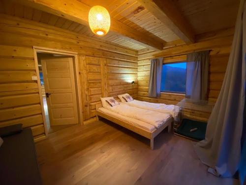 a bedroom with a bed in a wooden house at Chata u Pietrka in Szczyrk