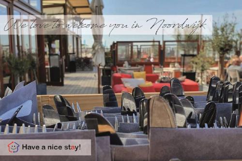 a row of empty chairs in a patio at Have a nice stay! - Blue Beach House 350 meters from sea in Noordwijk aan Zee