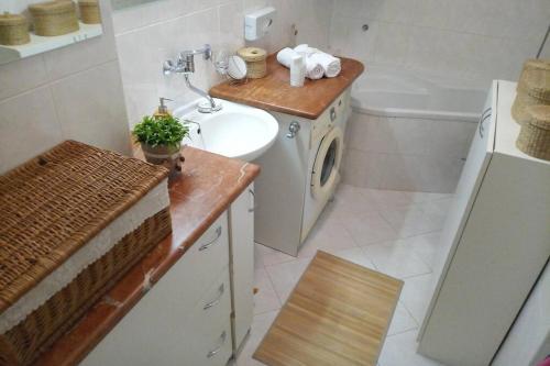 a bathroom with a sink and a toilet and a sink at ŽiLiNA Apartment in Žilina
