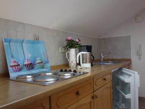 a kitchen with a counter top with plates and cupcakes at Spechthäusl in Bayerisch Gmain