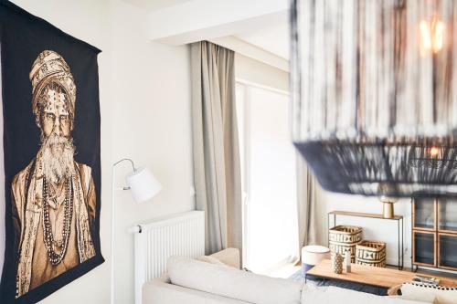 a living room with a portrait of a man at Diamant 1BR in Brussels
