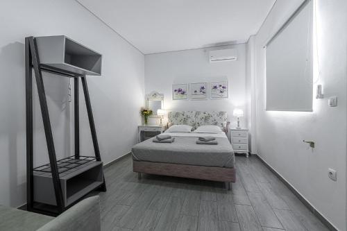 a bedroom with a bed in a white room at Comfort Stay Athens Airport Hotel - FREE shuttle from and to the airport in Spáta