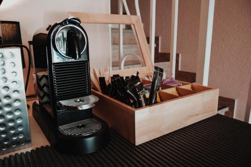 a black hair dryer sitting next to a wooden box at Hôtel PRADO avec Parking - Proche Zénith in Toulouse