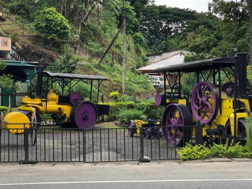 a train on display on the side of a fence at Kandyan Lounge in Kiribatkumbura