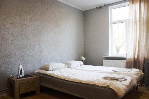 a bed in a room with a window and a bed sidx sidx sidx at Varnu Apartment in Rīga
