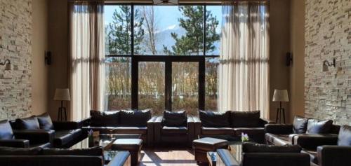 a large living room with couches and a large window at Terra Hotel in Bansko