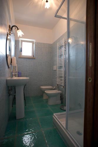 a bathroom with two toilets and a sink and a shower at L'Ulivo Sul Mare in Cetraro