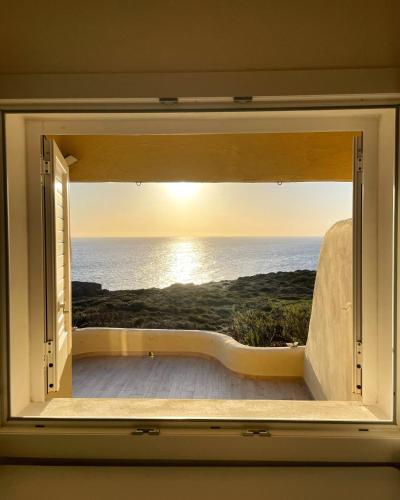a window with a view of the ocean at Villa Antioco in Cala Sapone