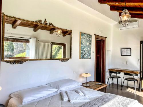 a bedroom with a bed and a table and a desk at Tenuta Novecento Bioagriturismo in Agerola