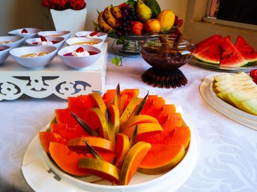 a table with a plate of fruit on a table at Hotel Canaã Express in Jarinu