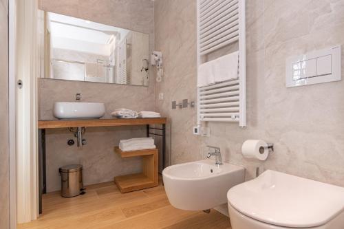 a bathroom with a sink and a toilet and a mirror at Borgo di Drugolo in Lonato del Garda