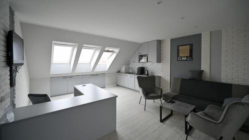 a living room with a couch and a table at Apartament Centrum Mazury - Szczytno in Szczytno