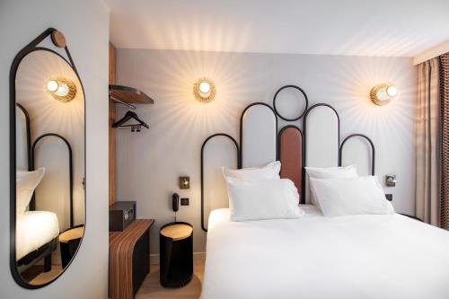 En eller flere senge i et værelse på Hotel de L'Esperance