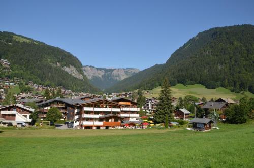 a resort in a valley with mountains in the background at La Clef des Champs in Morzine