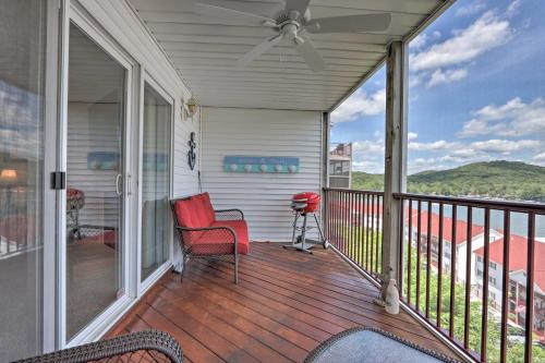 a porch with a red chair and a ceiling fan at The Lake Escape with Balcony and Pool Access! in Camdenton