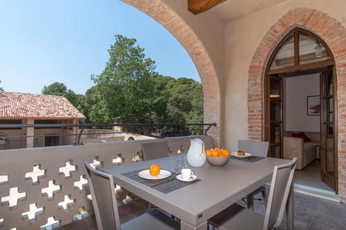 an outdoor patio with a white table and chairs at Borgo di Drugolo in Lonato del Garda