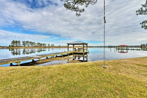 a dock with a gazebo on a lake at Waterside Belhaven House and Cottage with Porch and Dock in Belhaven