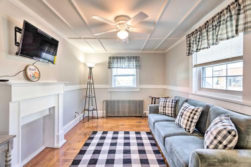 a living room with a couch and a tv at Newport House Less Than 3 Mi to Beaches and Bowens Wharf! in Newport