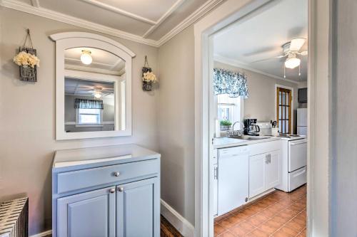 a kitchen with white cabinets and a mirror at Newport House Less Than 3 Mi to Beaches and Bowens Wharf! in Newport