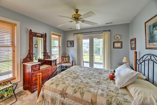 a bedroom with a bed and a ceiling fan at Waterside Belhaven House and Cottage with Porch and Dock in Belhaven
