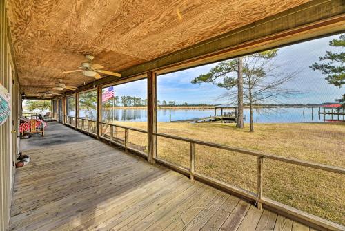 an empty porch with a view of the water at Waterside Belhaven House and Cottage with Porch and Dock in Belhaven