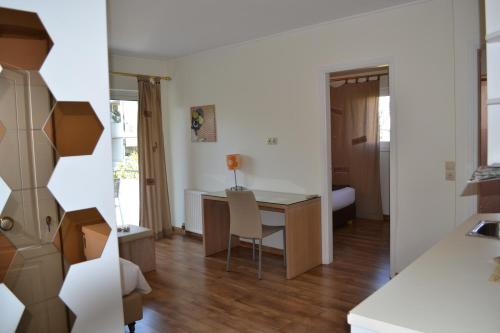 a small room with a desk and a bedroom at Rivitel Marousi Apartments in Athens