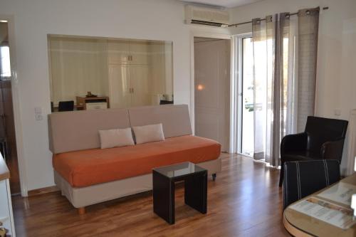 a living room with a couch and a chair at Rivitel Marousi Apartments in Athens